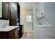 Well-organized bathroom with stackable washer/dryer, sink with vanity, and storage shelving at 921 24Th N Ave, St Petersburg, FL 33704