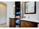 Bathroom with dual vanities, dark wood cabinets, open shelving, and ample storage at 921 24Th N Ave, St Petersburg, FL 33704