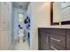 Bathroom featuring a dark vanity with a countertop sink and shower with decorative curtain at 921 24Th N Ave, St Petersburg, FL 33704