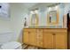 Bathroom with double sink vanity, granite countertop, and modern flooring at 921 24Th N Ave, St Petersburg, FL 33704