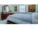 Bright bedroom with dresser, art decor and white shuttered windows at 921 24Th N Ave, St Petersburg, FL 33704