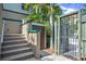 Inviting entryway features lush tropical landscaping and a secure gate, offering privacy and curb appeal at 921 24Th N Ave, St Petersburg, FL 33704