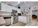 A spacious kitchen boasts stainless steel appliances, white cabinets, and light countertops at 921 24Th N Ave, St Petersburg, FL 33704