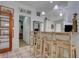 The kitchen highlights an open design with bar seating, white cabinetry, and tiled flooring at 921 24Th N Ave, St Petersburg, FL 33704
