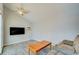 Bright living room featuring wood-look tile flooring, a comfortable sofa, and a large flat-screen TV at 921 24Th N Ave, St Petersburg, FL 33704
