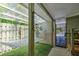 A covered patio with a hammock and artificial grass creates a relaxed outdoor experience at 921 24Th N Ave, St Petersburg, FL 33704