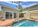 Backyard pool and spa area with brickwork, complemented by a well-maintained exterior and lush greenery at 921 24Th N Ave, St Petersburg, FL 33704