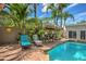 Inviting pool area surrounded by lush greenery and a charming tiki hut, creating a relaxing outdoor oasis at 921 24Th N Ave, St Petersburg, FL 33704