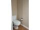 A compact toilet and neutral wallpaper enhance this efficient space at 921 24Th N Ave, St Petersburg, FL 33704