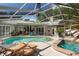 This backyard features a covered patio with a pool and hot tub, perfect for year-round outdoor enjoyment at 9322 Wellington Park Cir, Tampa, FL 33647