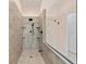 Updated shower with tile surround, rainfall shower head, and glass enclosure at 9322 Wellington Park Cir, Tampa, FL 33647