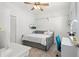 Bright bedroom featuring a daybed, ceiling fan, a desk, and white walls at 9322 Wellington Park Cir, Tampa, FL 33647