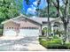 Charming single-story home with a well-manicured lawn, attached two-car garage and beautiful curb appeal at 9322 Wellington Park Cir, Tampa, FL 33647