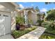 Charming home exterior with manicured landscaping, pathway, and inviting entrance at 9322 Wellington Park Cir, Tampa, FL 33647