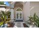 Inviting front entrance with double doors, decorative wreaths, and well-maintained landscaping at 9322 Wellington Park Cir, Tampa, FL 33647