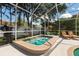 Inviting screened-in hot tub perfect for unwinding, with serene backyard views and lounge chairs at 9322 Wellington Park Cir, Tampa, FL 33647