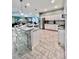 Spacious kitchen featuring a large island, granite countertops, stainless steel appliances, and tiled floors at 9322 Wellington Park Cir, Tampa, FL 33647