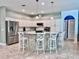 Spacious kitchen with white cabinets, an island bar, and stainless steel appliances at 9322 Wellington Park Cir, Tampa, FL 33647