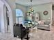 Comfortable living room with stylish decor, plush seating, and a decorative chandelier at 9322 Wellington Park Cir, Tampa, FL 33647