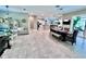 Expansive living room featuring tile flooring, high ceilings, and seamless access to the outdoor lanai at 9322 Wellington Park Cir, Tampa, FL 33647