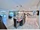 Open concept living area with a dining table, kitchen bar, and lots of seating at 9322 Wellington Park Cir, Tampa, FL 33647