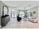 Bright living room featuring tiled floors, elegant furnishings, and a decorative chandelier at 9322 Wellington Park Cir, Tampa, FL 33647