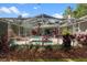 Screened lanai with a heated pool and spa, beautiful landscaping, and a covered patio at 9322 Wellington Park Cir, Tampa, FL 33647
