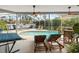 Screened in pool area with lounge chairs, ceiling fans, and lush landscaping at 9322 Wellington Park Cir, Tampa, FL 33647