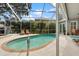 Screened pool with patio and beautiful landscaping, ideal for relaxing and entertaining at 9322 Wellington Park Cir, Tampa, FL 33647