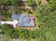 Aerial view of private home with large backyard and fenced in swimming pool at 9801 Pine Leaf Ln, Dade City, FL 33525