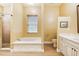 Bathroom with a soaking tub, walk-in shower, and a vanity with drawers at 9801 Pine Leaf Ln, Dade City, FL 33525