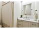 Bathroom featuring neutral walls, sink, cabinet, mirror and shower with patterned curtain at 9801 Pine Leaf Ln, Dade City, FL 33525