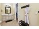 Bathroom featuring a white vanity with decorative hardware, with a bathrobe on the wall at 9801 Pine Leaf Ln, Dade City, FL 33525