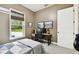 Bedroom includes window and desk, neutral walls, and modern decor at 9801 Pine Leaf Ln, Dade City, FL 33525