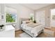 Bedroom featuring a bed with white bedding, views from windows and access to desk and chair area at 9801 Pine Leaf Ln, Dade City, FL 33525