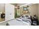 Bedroom features gray walls, multiple windows, skateboards on the wall, and a closet at 9801 Pine Leaf Ln, Dade City, FL 33525