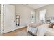 Bedroom with a door leading to a patio and a view of a bathroom with a white vanity at 9801 Pine Leaf Ln, Dade City, FL 33525