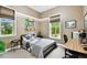 Bedroom features multiple windows, gray walls, skateboard wall art, and workspace at 9801 Pine Leaf Ln, Dade City, FL 33525