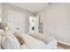 Bedroom with two closet doors, views into the living room, a bed, and hardwood floors at 9801 Pine Leaf Ln, Dade City, FL 33525