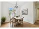 Bright dining room with a wood table, chandelier, and large window at 9801 Pine Leaf Ln, Dade City, FL 33525