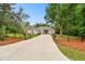 Charming single Gathering home with long driveway, mature trees, and well-manicured lawn at 9801 Pine Leaf Ln, Dade City, FL 33525
