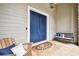 Lovely front porch with porch swing, seating, and double door entrance at 9801 Pine Leaf Ln, Dade City, FL 33525