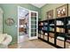 Home office with built-in bookshelves and office space, leading to the kitchen at 9801 Pine Leaf Ln, Dade City, FL 33525