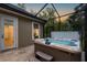 Exterior view of a hot tub and access door, providing a private relaxation space with easy access to the house at 9801 Pine Leaf Ln, Dade City, FL 33525