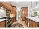 Modern kitchen featuring stainless steel appliances, tile backsplash and view to the backyard at 9801 Pine Leaf Ln, Dade City, FL 33525