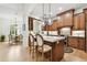 Gourmet kitchen featuring custom cabinets, quartz countertops, and stainless steel appliances at 9801 Pine Leaf Ln, Dade City, FL 33525