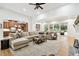 Open-concept living area with hardwood floors and view of the outdoor pool area at 9801 Pine Leaf Ln, Dade City, FL 33525