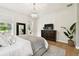 Tranquil bedroom featuring a crystal chandelier, large dresser, and backyard views at 9801 Pine Leaf Ln, Dade City, FL 33525