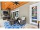 Outdoor patio with stone fireplace and a dining table, with access to the backyard pool at 9801 Pine Leaf Ln, Dade City, FL 33525
