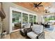 Inviting covered patio showcases sliding glass doors, chairs, and a view of the backyard pool area at 9801 Pine Leaf Ln, Dade City, FL 33525